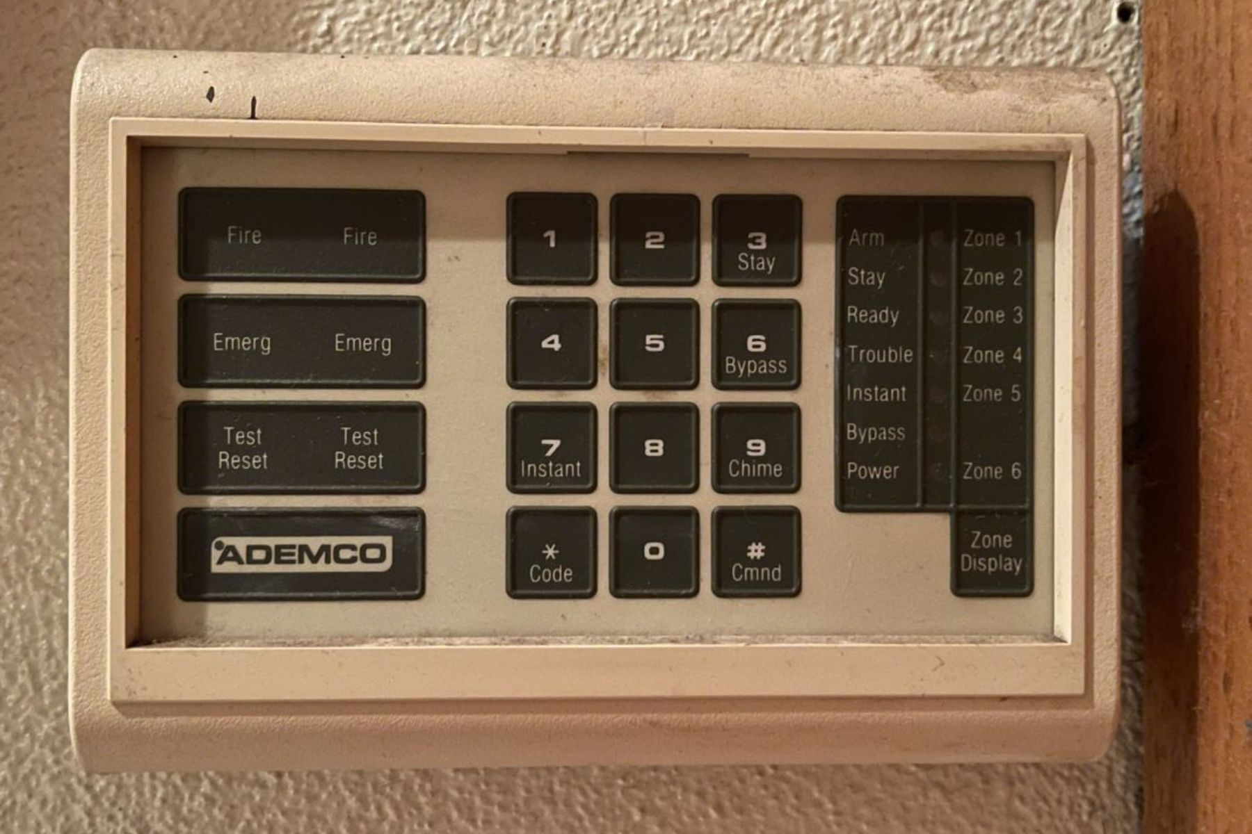 An old outdated alarm keypad that is witness to needing to upgrade security system.